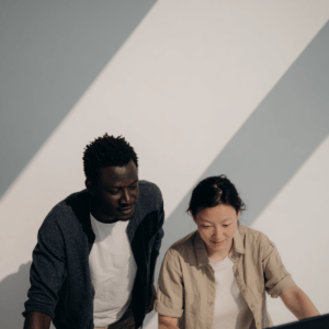 Two people working together, focused in a collaborative workspace.